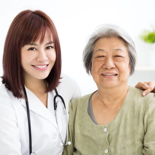young smiling home caregiver with senior woman young smiling home caregiver with senior woman